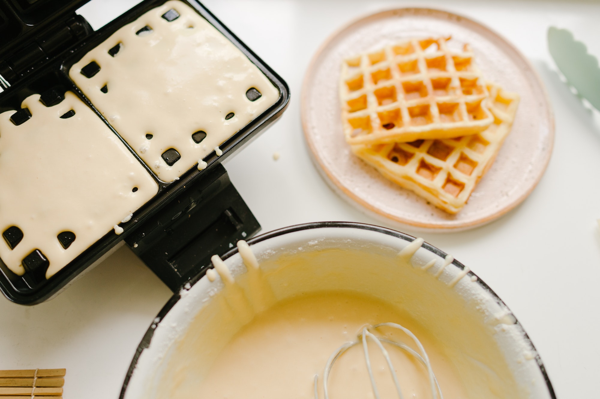 cooking Belgian waffles in waffle iron, batter